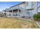 Backyard view of house featuring a patio area with outdoor seating and a staircase leading to an upper deck at 26741 E Peakview Pl, Aurora, CO 80016