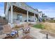 Spacious backyard featuring a patio area with outdoor seating, fire pit, and a well-maintained lawn at 26741 E Peakview Pl, Aurora, CO 80016