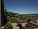 Serene backyard featuring a stone patio, fire pit, and manicured landscaping with views of the open landscape at 26741 E Peakview Pl, Aurora, CO 80016