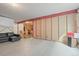 Unfinished basement area showing a large open space, wood framing, and a dark colored leather couch at 26741 E Peakview Pl, Aurora, CO 80016