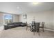Basement living area with comfortable seating, dining space, and a large window for natural light at 26741 E Peakview Pl, Aurora, CO 80016