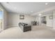 Open basement layout with comfortable seating, a dining area, and access to the outdoors at 26741 E Peakview Pl, Aurora, CO 80016