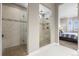 Luxury bathroom featuring marble tile shower and bedroom view at 26741 E Peakview Pl, Aurora, CO 80016