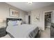 Comfortable bedroom with neutral walls, plush carpet, and an adjacent closet and hallway at 26741 E Peakview Pl, Aurora, CO 80016