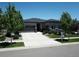 Charming home with a well-manicured lawn, spacious driveway, and inviting curb appeal on a sunny day at 26741 E Peakview Pl, Aurora, CO 80016