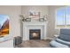 Bright living room features a cozy fireplace, tile surround, and a large window at 26741 E Peakview Pl, Aurora, CO 80016