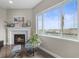 Bright living room features a cozy fireplace with tile surround, and a large window with water views at 26741 E Peakview Pl, Aurora, CO 80016