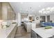 Bright, open kitchen boasts stainless appliances, island, and seamless flow to dining and living areas at 26741 E Peakview Pl, Aurora, CO 80016
