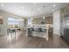 Spacious kitchen with stainless steel appliances, large island, dining area, and hardwood floors at 26741 E Peakview Pl, Aurora, CO 80016