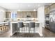Modern kitchen features white countertops, stainless steel appliances, pendant lighting, and an adjacent dining area, perfect for entertaining at 26741 E Peakview Pl, Aurora, CO 80016