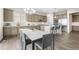 Modern kitchen features white countertops, stainless steel appliances, pendant lighting, and an adjacent dining area, perfect for entertaining at 26741 E Peakview Pl, Aurora, CO 80016