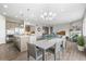 Open floor plan shows kitchen with stainless appliances, dining area, and living room with fireplace and hardwood floors at 26741 E Peakview Pl, Aurora, CO 80016