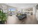 Open-concept living room features hardwood floors, a fireplace, and large windows with views of the landscape at 26741 E Peakview Pl, Aurora, CO 80016
