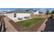 Well-manicured backyard features a small lawn, patio set, and a decorative border at 7222 Aspen Brook Ave, Frederick, CO 80530