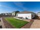Lush backyard features a well-kept lawn, patio seating, and a cozy outdoor living area at 7222 Aspen Brook Ave, Frederick, CO 80530