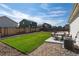 Lush backyard showcasing a green lawn, gravel border, and comfortable patio furniture at 7222 Aspen Brook Ave, Frederick, CO 80530