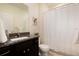 Modern bathroom features a granite vanity, framed art, and a shower with white curtain at 7222 Aspen Brook Ave, Frederick, CO 80530