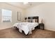 Inviting bedroom with a comfortable bed, soft carpet, and natural light from the window at 7222 Aspen Brook Ave, Frederick, CO 80530