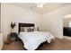 Bright bedroom includes a bed with decorative pillows and a view of a bathroom at 7222 Aspen Brook Ave, Frederick, CO 80530