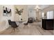 A dining area showcases a glass table with chairs and is adjoined to a living room and modern kitchen at 7222 Aspen Brook Ave, Frederick, CO 80530