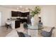 A dining area and a modern kitchen with granite counters & stainless steel appliances are featured at 7222 Aspen Brook Ave, Frederick, CO 80530