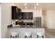 Modern kitchen featuring granite countertops, stainless steel appliances, and stylish breakfast bar seating at 7222 Aspen Brook Ave, Frederick, CO 80530