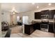 A charming kitchen with granite counters is connected to a carpeted living room with neutral furniture at 7222 Aspen Brook Ave, Frederick, CO 80530