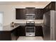 The kitchen features granite countertops, stainless steel appliances, and sleek dark wood cabinetry at 7222 Aspen Brook Ave, Frederick, CO 80530