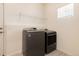 Neat laundry room with gray washer and dryer and a wire rack for storage at 7222 Aspen Brook Ave, Frederick, CO 80530