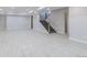 Large finished basement with gray tile flooring, recessed lighting, and staircase at 29585 E 165Th Ave, Brighton, CO 80603