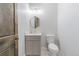 Stylish powder room featuring modern fixtures, a decorative mirror and patterned floor at 29585 E 165Th Ave, Brighton, CO 80603