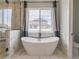 Luxurious bathroom featuring a soaking tub with floor-mounted tub filler at 29585 E 165Th Ave, Brighton, CO 80603