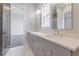 Bathroom featuring double sink vanity, quartz countertop, and framed mirrors at 29585 E 165Th Ave, Brighton, CO 80603