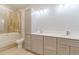 Bathroom boasts double sinks, quartz countertops, and a tiled shower over tub at 29585 E 165Th Ave, Brighton, CO 80603
