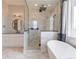 Well-lit bathroom with walk-in glass shower, soaking tub and white marble finishes at 29585 E 165Th Ave, Brighton, CO 80603
