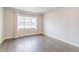 Light-filled bedroom boasts hardwood floors and a large window with neighborhood views at 29585 E 165Th Ave, Brighton, CO 80603