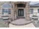 Detailed entrance with custom iron door, stone pillars, and decorative planters at 29585 E 165Th Ave, Brighton, CO 80603