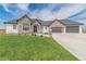 Charming home featuring stone accents, a well-manicured lawn, and a spacious driveway at 29585 E 165Th Ave, Brighton, CO 80603