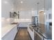 Modern kitchen with white cabinets, stainless steel appliances, marble countertops and center island at 29585 E 165Th Ave, Brighton, CO 80603