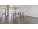 Open-concept living area with hardwood floors, stone pillar, and natural light at 29585 E 165Th Ave, Brighton, CO 80603