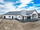 Back of house featuring a covered patio, black trim, and a large yard at 29585 E 165Th Ave, Brighton, CO 80603