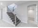 View of the staircase with wood steps, metal railing, and neutral-toned walls at 29585 E 165Th Ave, Brighton, CO 80603