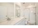 Modern bathroom with dual sinks, quartz counters, and walk-in shower at 700 N Bently St, Watkins, CO 80137