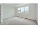 Bright bedroom with large windows and plush carpeting at 700 N Bently St, Watkins, CO 80137