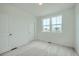 Bright and airy bedroom with plush carpeting and a pair of windows at 700 N Bently St, Watkins, CO 80137