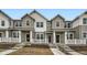 Charming townhomes featuring a modern farmhouse design and inviting front porches at 700 N Bently St, Watkins, CO 80137