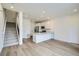 Modern kitchen with stainless steel appliances and a breakfast bar, open to the living area at 700 N Bently St, Watkins, CO 80137