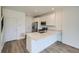 Well-lit kitchen featuring stainless steel appliances, white cabinets, and breakfast bar at 700 N Bently St, Watkins, CO 80137