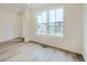 Bright living room with wood floors and large windows showing the neighborhood outside at 700 N Bently St, Watkins, CO 80137