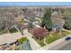 Aerial view highlighting the home's exterior, garage, and neatly kept yard within a suburban setting at 4625 S Huron St, Englewood, CO 80110